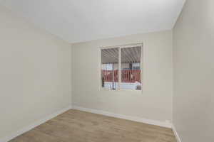 Spare room with light wood-type flooring