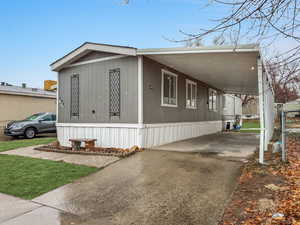 View of side of property with a carport