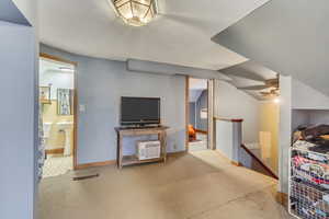 Interior space featuring ensuite bath and vaulted ceiling