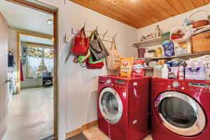 Laundry area featuring separate washer and dryer and wood ceiling