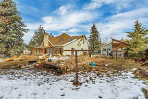 View of snow covered back of property