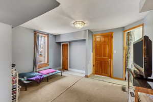 Bedroom featuring light colored carpet and a closet