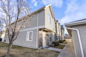 View of side of property featuring a lawn