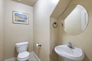 Bathroom featuring tile patterned floors, toilet, and sink