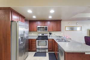 Kitchen with stainless steel appliances, sink, and kitchen peninsula