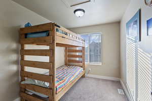 Bedroom featuring light colored carpet