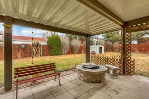 View of patio / terrace with a storage shed and a fire pit