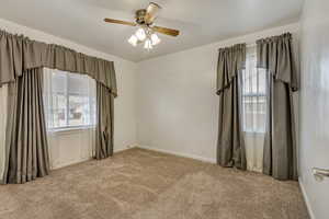 Unfurnished room featuring light carpet and ceiling fan