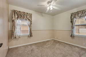 Unfurnished room with ceiling fan and carpet flooring