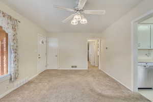 Empty room featuring ceiling fan and light colored carpet