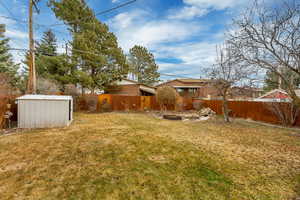 View of yard featuring a shed and a water fountain