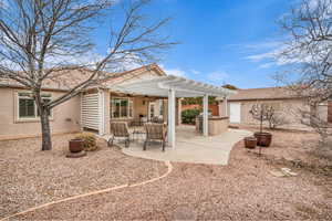 Rear view of house with a pergola and a patio