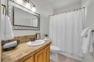 Bathroom with vanity, toilet, and tile patterned flooring