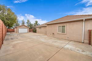 View of side of property featuring an outbuilding and a garage