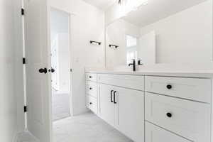 Bathroom featuring vanity and marble finish floor