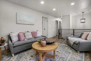 Living room featuring a notable chandelier and light hardwood / wood-style flooring