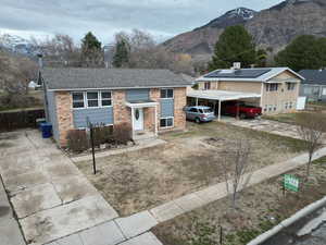 View of front of house with a mountain view and a carport