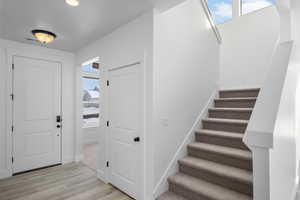 Foyer entrance with light hardwood / wood-style floors