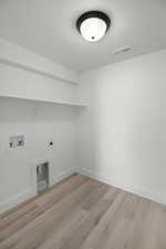 Laundry room featuring electric dryer hookup, washer hookup, and light wood-type flooring