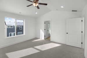 Unfurnished bedroom with lofted ceiling, light colored carpet, and ceiling fan