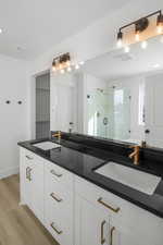 Bathroom featuring vanity, a shower with shower door, and hardwood / wood-style floors