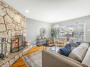 Living room featuring hardwood floors and a wood burning fireplace