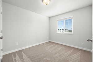 Empty room featuring carpet flooring