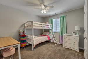 Carpeted bedroom with ceiling fan