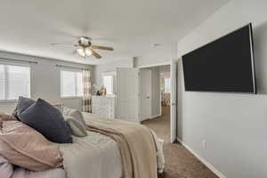 Carpeted bedroom with ceiling fan