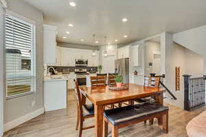 Dining space with sink and light hardwood / wood-style floors