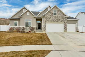 Craftsman-style house featuring a garage and a front yard