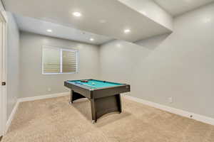 Playroom with light carpet and pool table