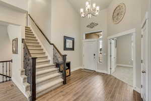 Foyer entrance with a towering ceiling and a chandelier