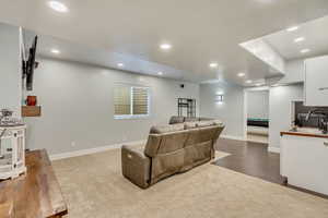 Living room with sink and light hardwood / wood-style floors