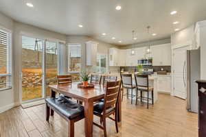 Dining space with light hardwood / wood-style flooring