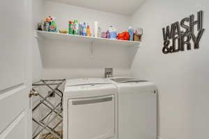 Washroom featuring washer and dryer