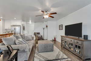 Living room featuring hardwood / wood-style flooring and ceiling fan