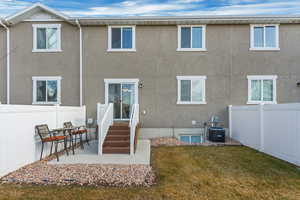 Rear view of house featuring a patio area, a lawn, and central air condition unit