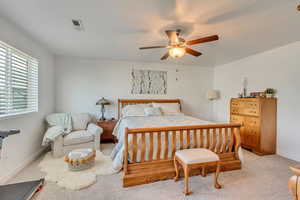 Bedroom with light colored carpet and ceiling fan