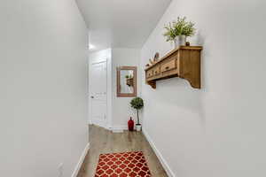 Corridor featuring light wood-type flooring