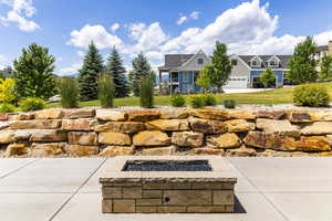 View of patio / terrace featuring a garage and a fire pit