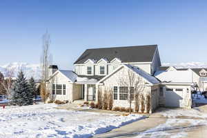 View of property with a mountain view and a garage