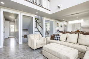 Living room featuring a high ceiling and light wood-type flooring