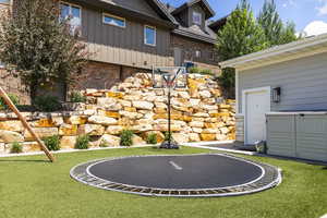 View of yard featuring a trampoline