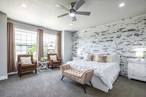 Bedroom with ceiling fan, carpet floors, and a textured ceiling