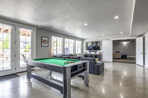 Rec room with pool table and a textured ceiling