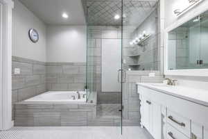 Bathroom featuring tile patterned flooring, vanity, and independent shower and bath