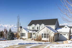 View of front property with a garage and a mountain view