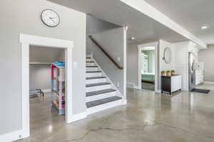 Staircase featuring concrete flooring and a textured ceiling