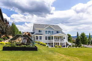 Rear view of house featuring a lawn